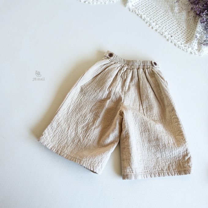 韓國 Jmsnail - 鬆緊腰鈕扣裝飾壓紋長褲-淺卡其