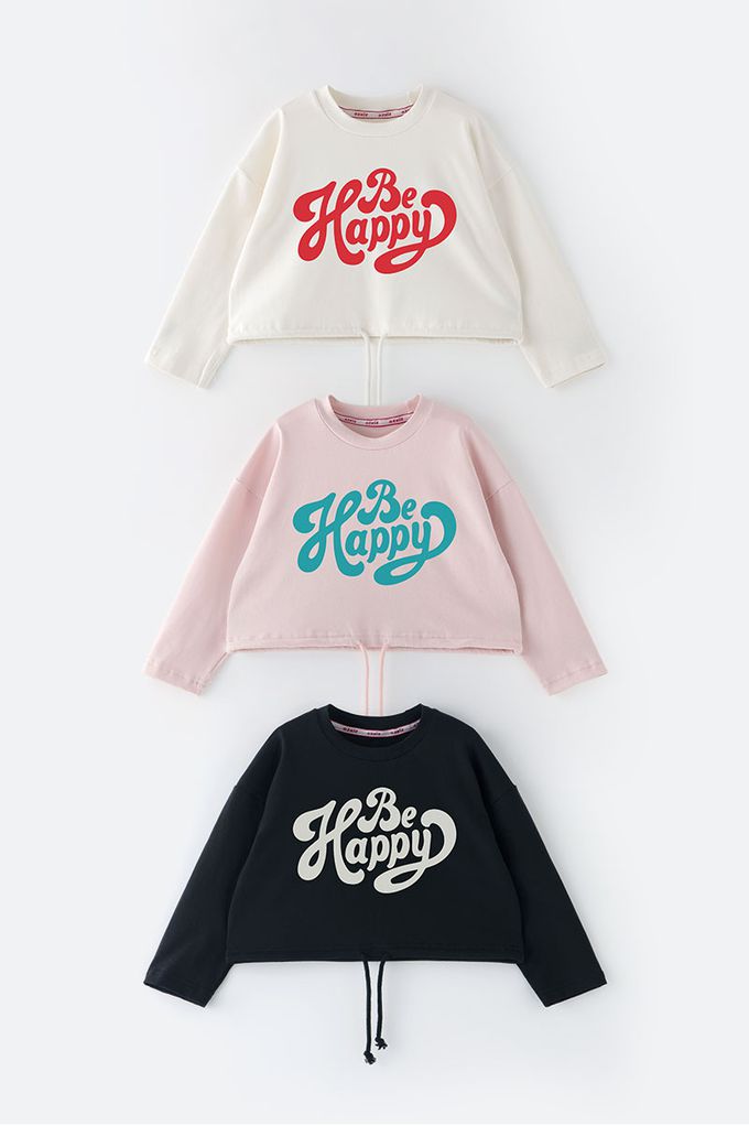 韓國 OZKIZ - 運動風字母印寬版長袖上衣-象牙白