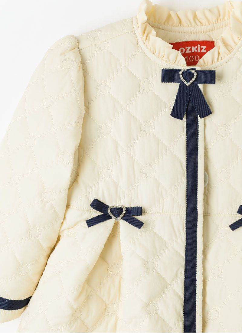 韓國 OZKIZ - 高雅愛心鑽蝴蝶結長版大衣-米白