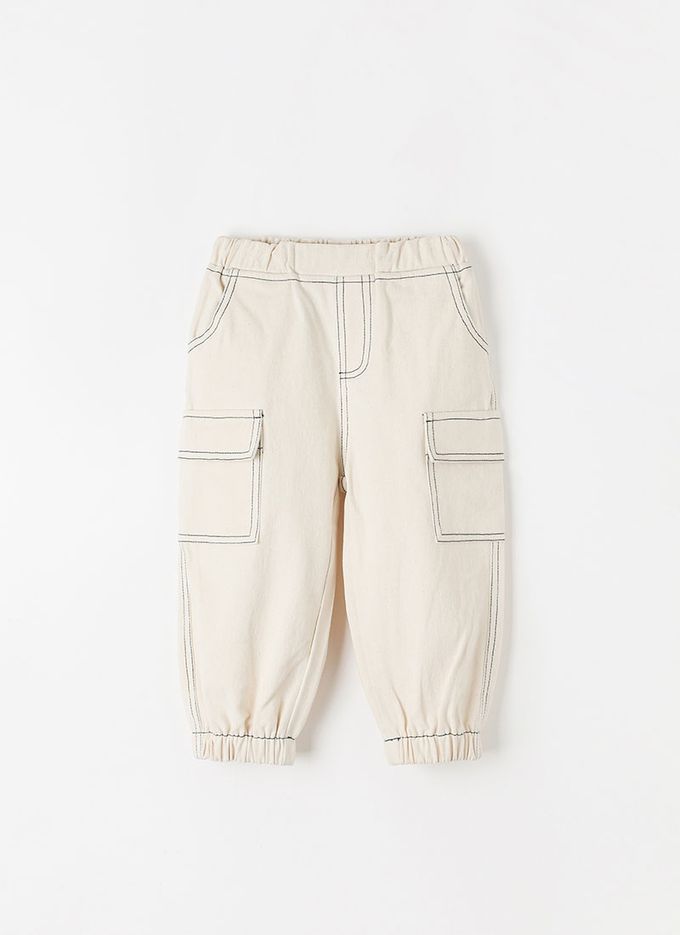 韓國 OZKIZ - 鬆緊腰縫線點綴縮口長褲-象牙白