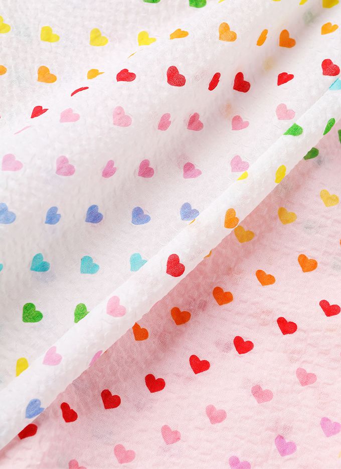 韓國 OZKIZ - 鬆緊腰滿版印花縮口防蚊褲-彩色愛心-淡粉