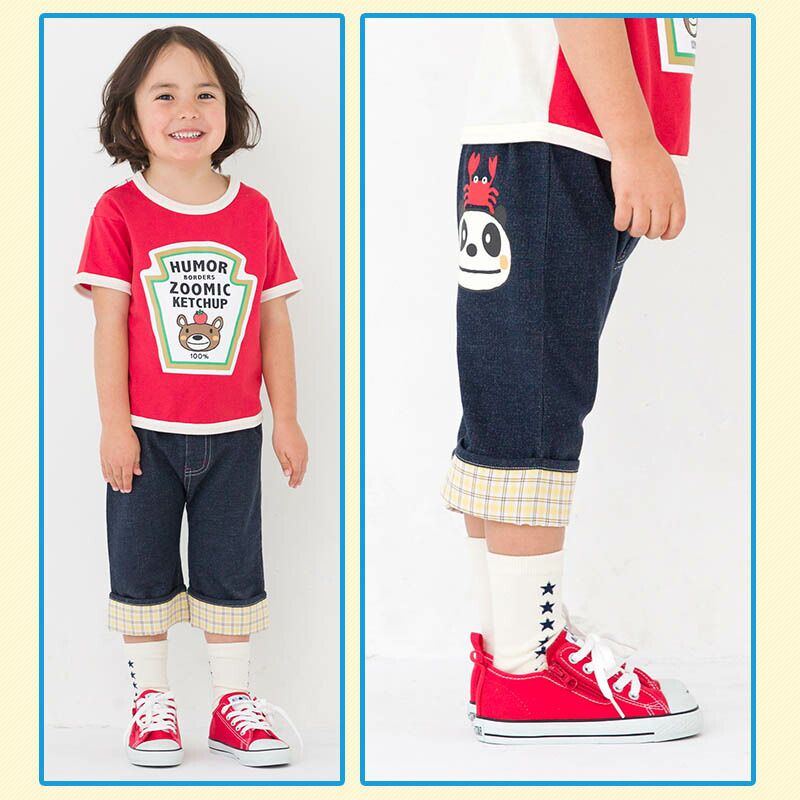 日本 ZOOLAND - 背後童趣印花下擺摺邊短褲-卡其